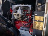 a close up of a red and black engine in the back of a truck