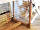 a wooden bench with a pillow on top of it