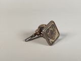 an image of a small metal object on a white surface