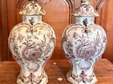 two vases that are sitting on a wooden table