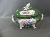 a green and white tureeny with a bird on it