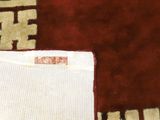 a close up of a rug with a piece of cloth on top of it