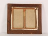 an old picture frame with a wooden handle and a piece of paper in it