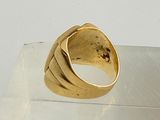 a gold ring sitting on top of a clear display case