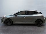 the silver car is parked on the concrete floor in the room