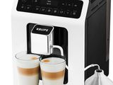 a close up of a coffee machine with two cups of coffee