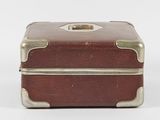 a small brown suitcase sitting on top of a white surface