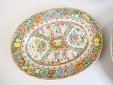 pair of chinese famille plates with birds and flowers on them