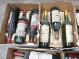 many bottles of wine in a box on the floor