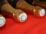 several bottles of wine are lined up on a red cloth