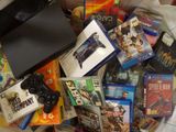 a pile of video games and games on a bed