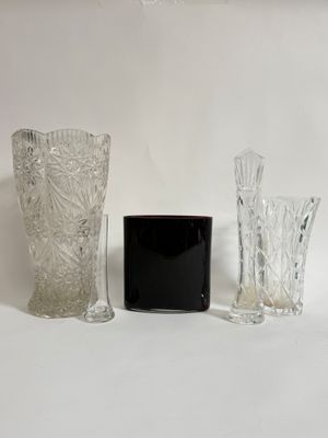three vases sitting next to each other on a white surface