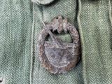 a close up of a coat with a badge on it