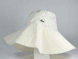 white bucket hat with a green alligator on the brimle