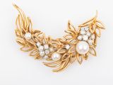 a gold and pearl broochle with leaves and pearls