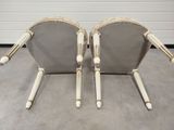 pair of chrome and wood chairs in the style of a pair of chairs
