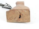 a small wooden object with a wire attached to it