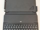 a black laptop with a black keyboard on a white table