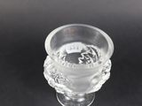 clear glass vase on a black table with a black background