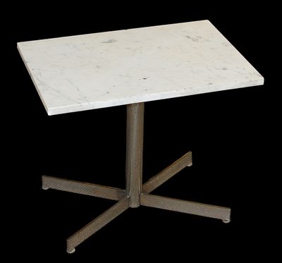 a white marble table with a metal base on a black background