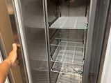 a man that is standing in front of an open refrigerator