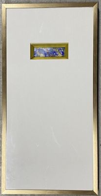 tableau représentant des fleurs bleues dans un cadre doré, accroché à un mur blanc