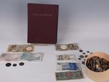 a box of coins and a book on a table
