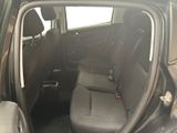 the back seats of a car with the door open in a parking lot