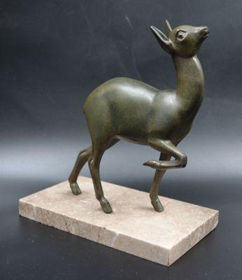 statue of a deer on a marble base on a black background