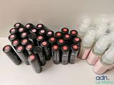 a lot of bottles of lip bales on the counter