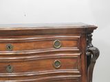 a wooden chest of drawers with brass knobs on it