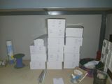 a pile of white boxes on a table next to other boxes
