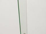 a glass and metal sculpture on a wooden table