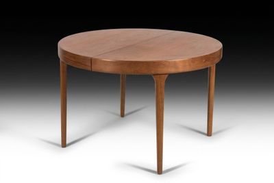 une table de salle à manger ronde à deux pieds, avec un plateau en bois