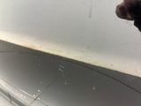a person that is cleaning a car with a rag