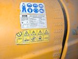 a close up of a yellow tank with a sticker on it