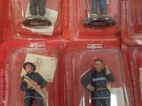 six figurines of a fireman in plastic cases