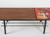 a coffee table with a painting on the top of it