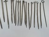 six pairs of metal scissors are lined up on a white surface