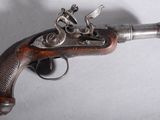 an old gun that is on display on a table