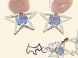 two pairs of earrings with a cat and a star on them