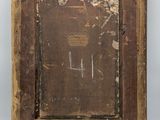 an old wooden picture frame with a picture of a man on it