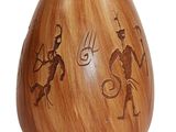 a wooden vase with a picture of a man and a woman on it