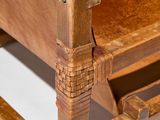 a close up of a wooden chair on a white surface