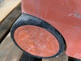 a red car that is sitting on a wooden pallet