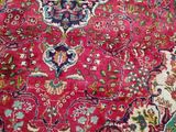 an image of a red oriental rug with a medallion design on it