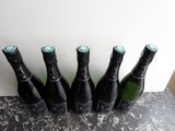 four bottles of wine are lined up on a table