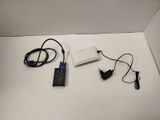 a white box with a black and blue device and a charger