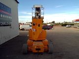 a yellow crane that is sitting in a parking lot