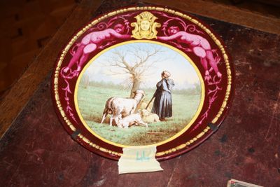 a plate with a picture of a man and a dog on it
